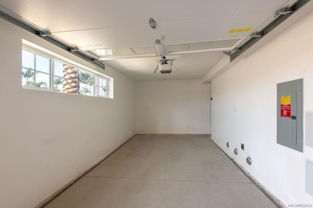 garage with a garage door opener and electric panel