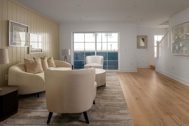 living room featuring wooden walls and hardwood / wood-style floors