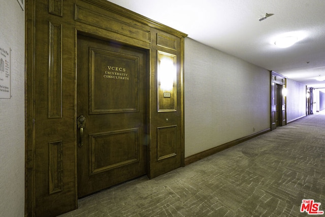 corridor with dark colored carpet