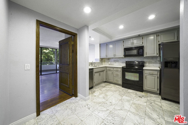 kitchen featuring backsplash, gray cabinets, crown molding, black appliances, and sink