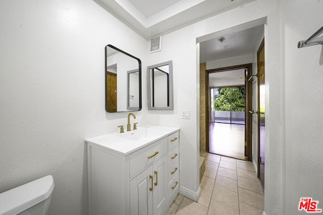 bathroom with tile patterned floors, vanity, and toilet