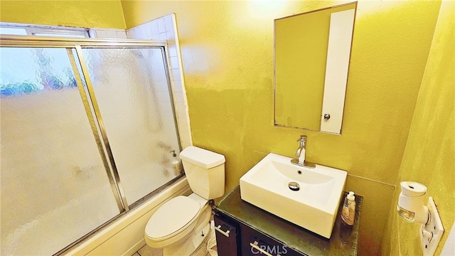 full bathroom with vanity, toilet, and bath / shower combo with glass door