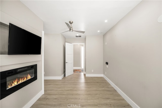 unfurnished living room with light hardwood / wood-style floors and ceiling fan