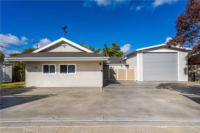 view of front of home with an outdoor structure and a garage