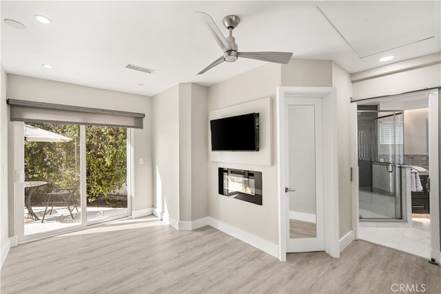 unfurnished living room with ceiling fan and light hardwood / wood-style flooring