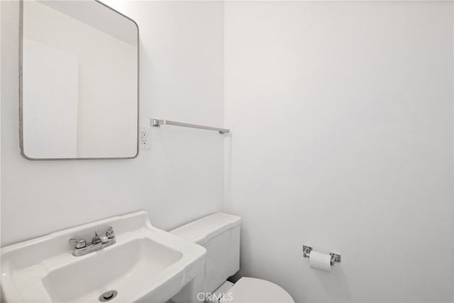 bathroom with toilet and sink