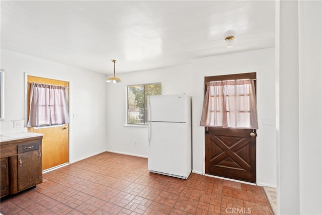 kitchen with pendant lighting and white refrigerator