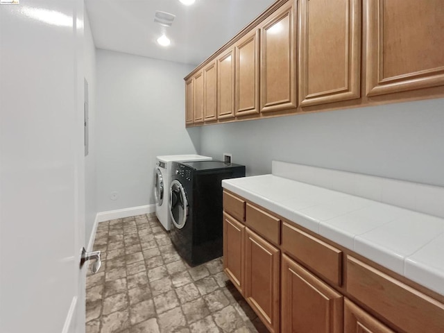 laundry area with cabinets and washing machine and dryer