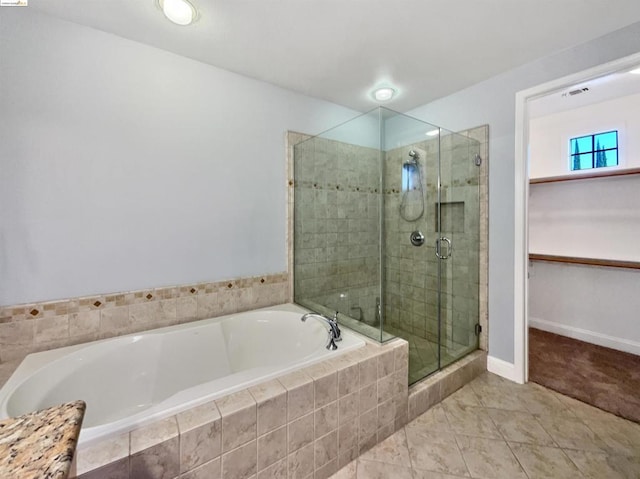 bathroom with tile patterned floors and shower with separate bathtub