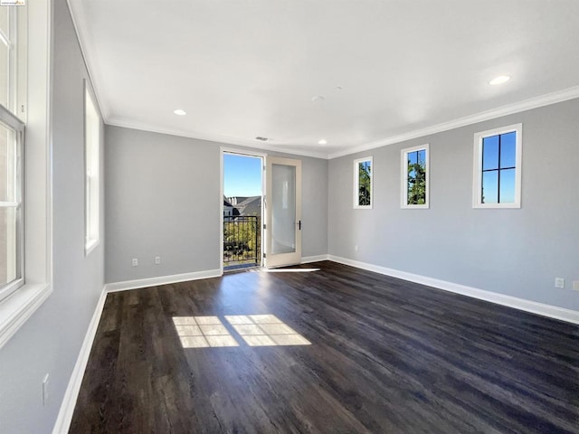 unfurnished room featuring dark hardwood / wood-style floors, crown molding, and a healthy amount of sunlight