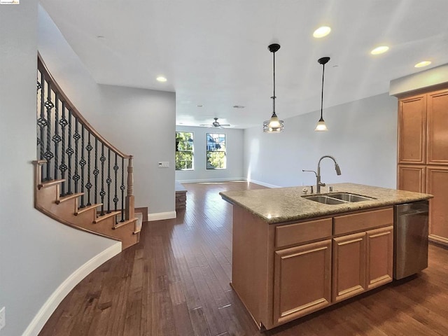 kitchen with ceiling fan, dishwasher, sink, dark wood-type flooring, and an island with sink