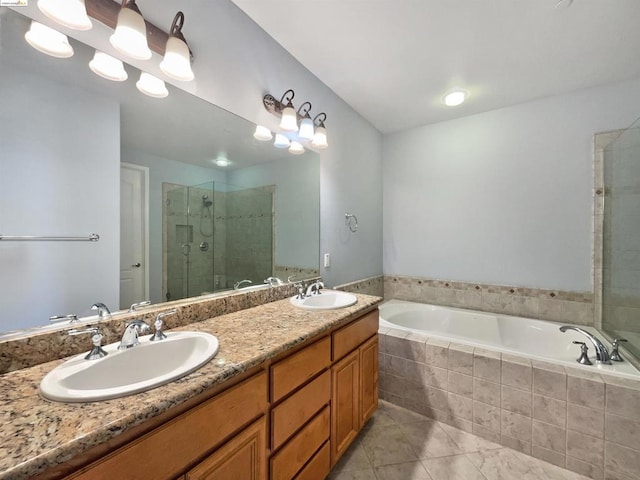 bathroom with vanity and independent shower and bath