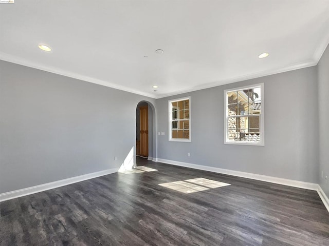 unfurnished room with dark wood-type flooring and ornamental molding