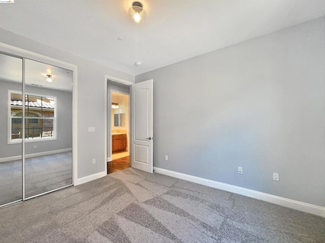 unfurnished bedroom featuring carpet and a closet