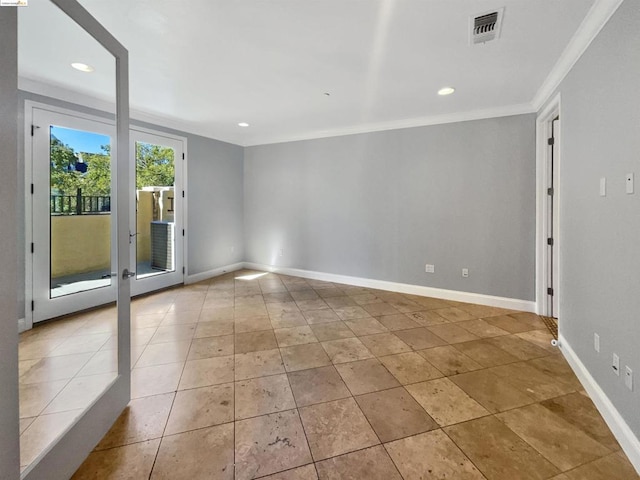 unfurnished room with ornamental molding and light tile patterned flooring