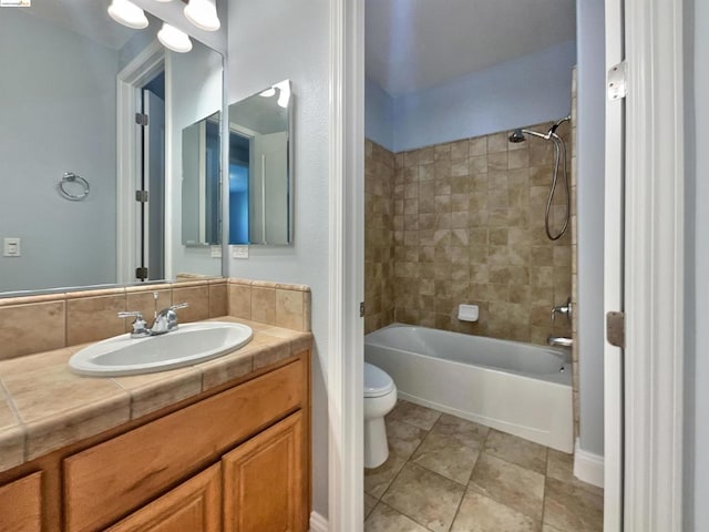 full bathroom with vanity, toilet, and tiled shower / bath