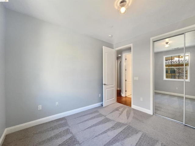 unfurnished bedroom with carpet and a closet