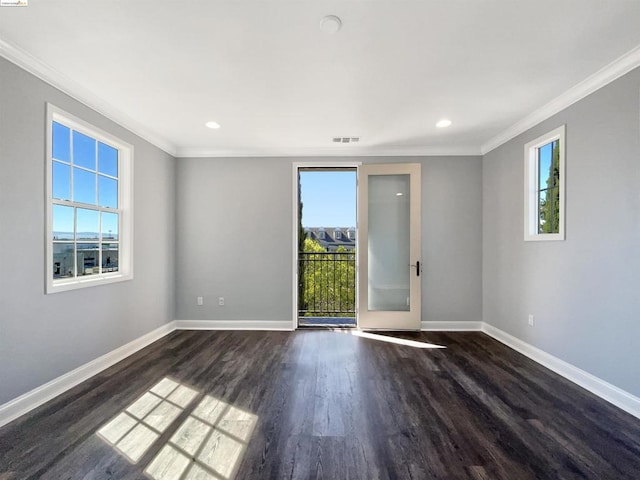 unfurnished room with a healthy amount of sunlight, dark hardwood / wood-style flooring, and crown molding