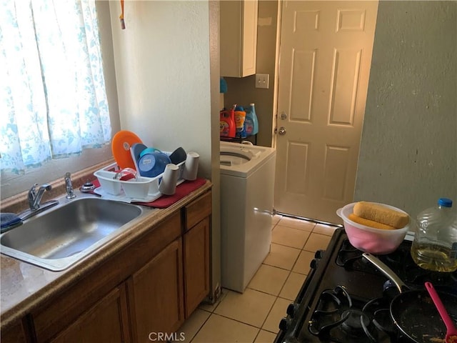 washroom with washer / clothes dryer, sink, and light tile patterned flooring