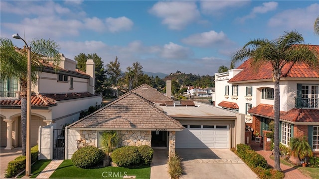 mediterranean / spanish home featuring a garage