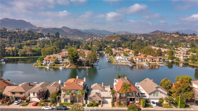 bird's eye view with a water and mountain view