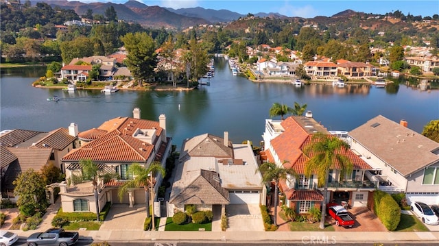 drone / aerial view featuring a water and mountain view