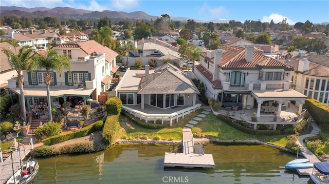 birds eye view of property featuring a water and mountain view