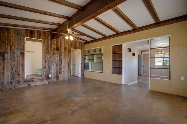 unfurnished room with vaulted ceiling with beams, wooden walls, concrete flooring, and ceiling fan