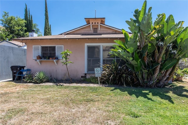 rear view of property featuring a yard