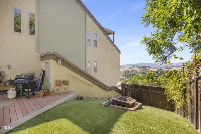 view of yard featuring a deck with mountain view