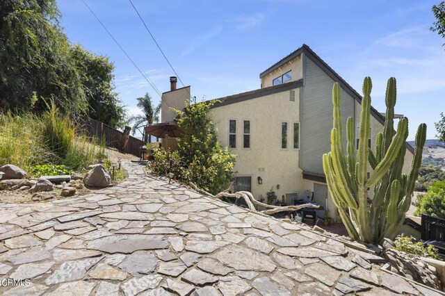 view of side of property featuring a patio area