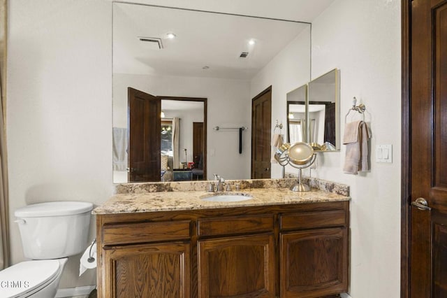 bathroom featuring vanity and toilet