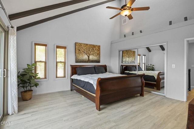 bedroom featuring high vaulted ceiling, beamed ceiling, a closet, ceiling fan, and light hardwood / wood-style flooring