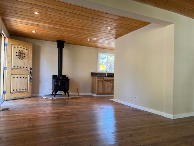 unfurnished living room with wood ceiling, dark wood-type flooring, and a wood stove