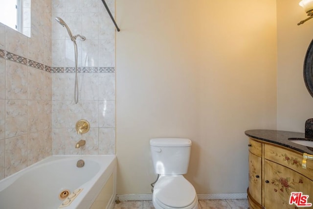 full bathroom featuring toilet, vanity, and tiled shower / bath combo