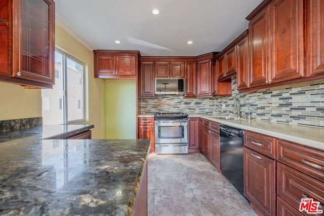 kitchen with backsplash, dark stone countertops, sink, and appliances with stainless steel finishes