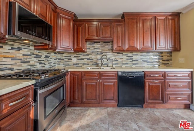 kitchen featuring sink, light tile patterned floors, backsplash, and appliances with stainless steel finishes