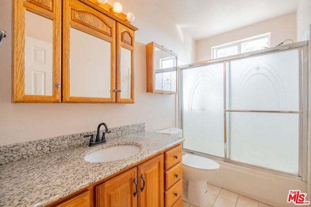 full bathroom with tile patterned flooring, vanity, toilet, and enclosed tub / shower combo