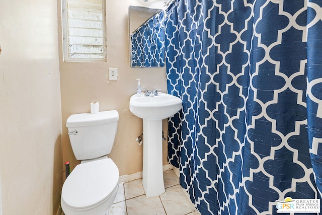 bathroom with sink, a shower with curtain, and toilet