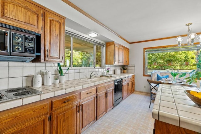 kitchen with sink, black dishwasher, backsplash, tile counters, and a healthy amount of sunlight