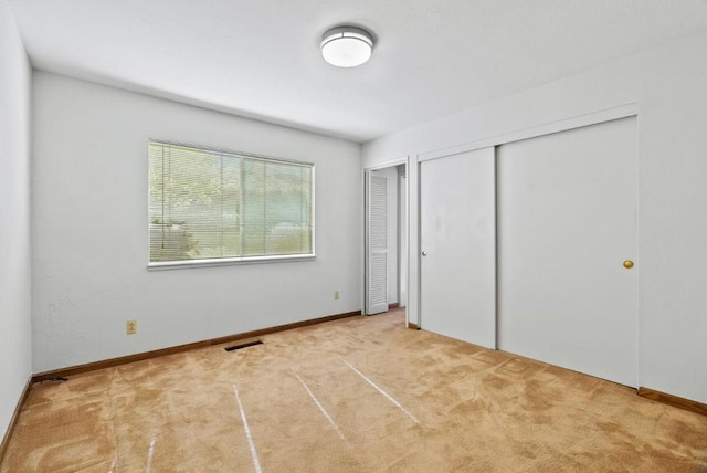 unfurnished bedroom with light carpet