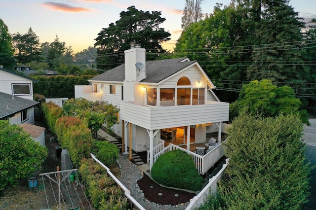 view of back house at dusk