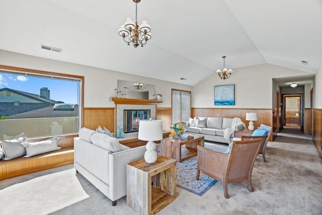 living room with an inviting chandelier, light carpet, and lofted ceiling