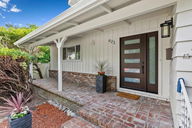 view of exterior entry with covered porch