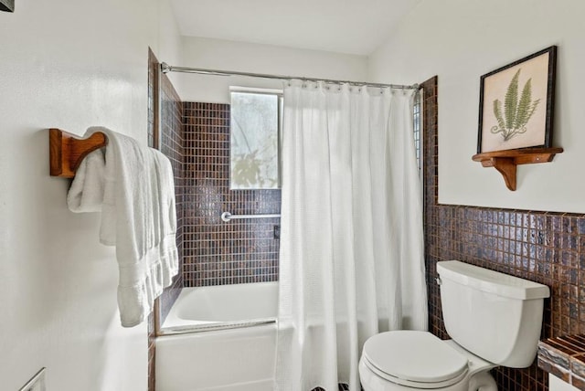 bathroom featuring toilet, tile walls, and shower / bath combo