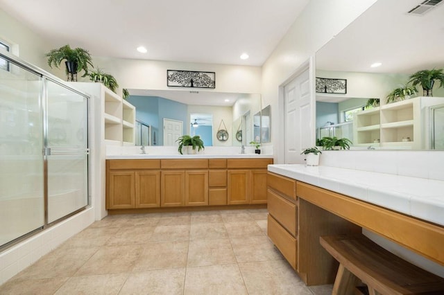 bathroom featuring tile patterned floors, vanity, ceiling fan, and a shower with door