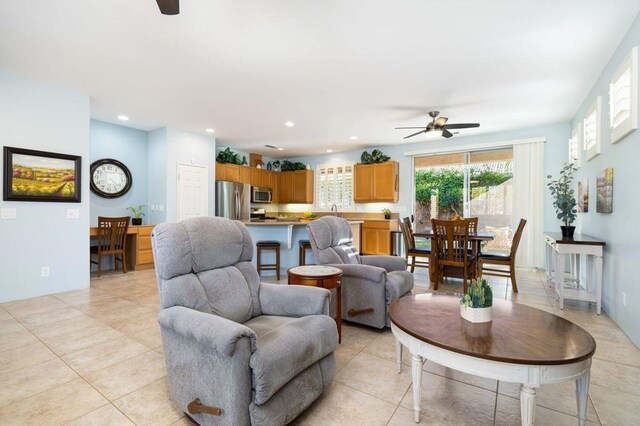 living room featuring ceiling fan and light tile patterned floors