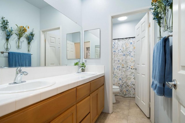 bathroom featuring tile patterned flooring, vanity, and toilet