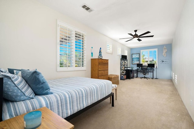 bedroom featuring light colored carpet and ceiling fan