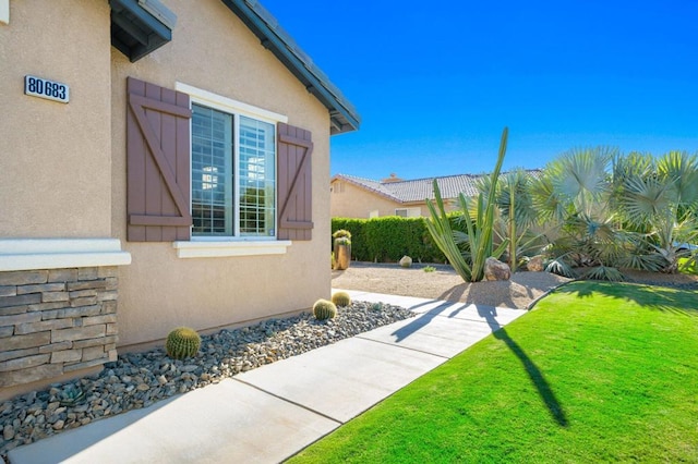 view of home's exterior with a yard